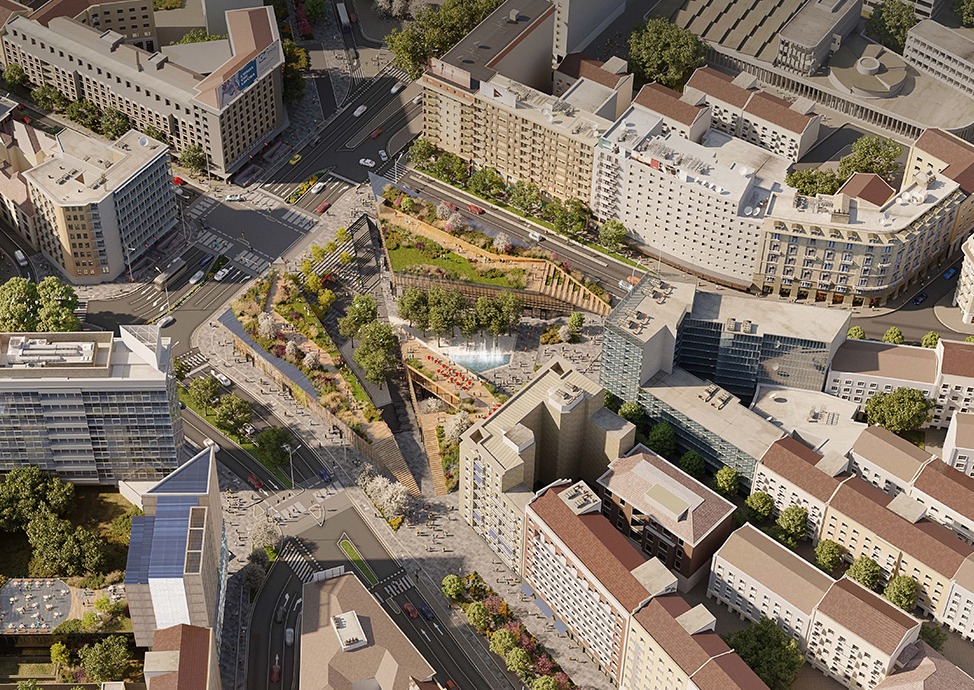Vista aerea del progetto di riqualificazione di Piazzale Loreto a Milano, con piazza verde ribassata, giardini, percorsi pedonali e spazi pubblici multilivello.